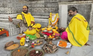 Priest performing Maa Baglamukhi Puja with traditional offerings and ritual items